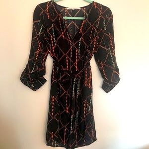 Black tie front dress with orange and green detail